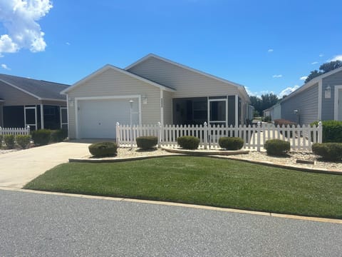 Front of house with private  driveway and a 1 1/2 car garage
