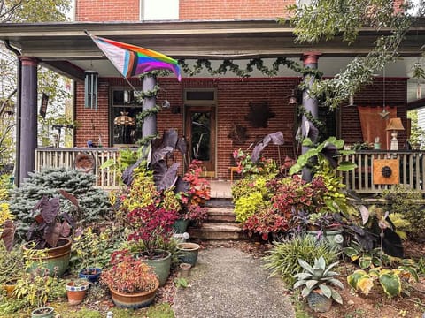 Charming front entrance surrounded by plants and character