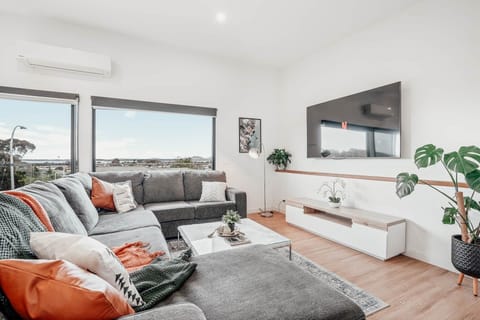 Enjoy mountain serenity, sunsets, an 85" TV, and lush indoor plants-all in your cozy living room!