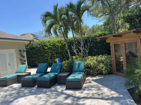 Kick back on poolside loungers under the shady pergola.