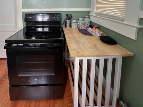 The cooking nook with a wooden counter where you can place all your utensils and spices within reach.