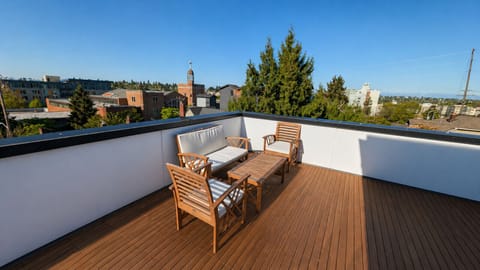 Featuring a spacious wooden deck and comfortable seating, it’s perfect for morning coffee or evening drinks, with open city views creating a calm and inviting atmosphere.