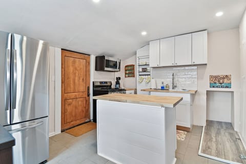 A newly remodeled and nice sized kitchen with butcher block countertops and center island