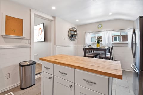 A newly remodeled and nice sized kitchen with butcher block countertops and center island