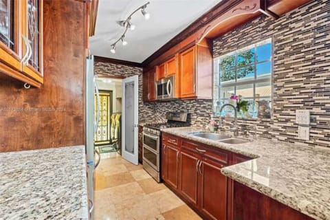 gorgeous, gourmet kitchen, features, stunning granite countertops, a beautiful backsplash and a gas range complemented by sleek stainless steel appliances. Equipped with everything you need to whip up a simple breakfast or gourmet meal, this space in
