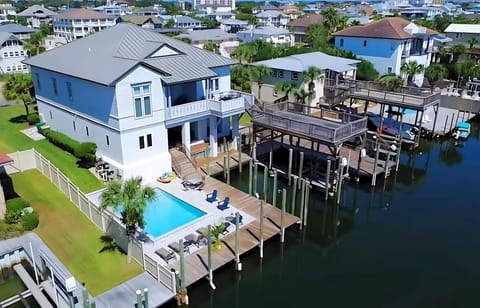 Welcome to Sandy Feet Retreat! Private Pool Overlooking canal, Private Dock & Boat Slip, Jet ski davit, Game Room, Balcony, Deck with BBQ Grill