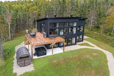 Spacious wooden deck, barrel sauna, and private wooded surroundings.