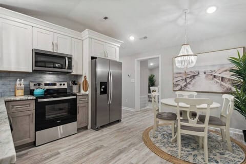 This well-equipped full kitchen provides everything you need to create delicious meals.  Top-of-the-line appliances, including a built-in oven, electric stove with four burners, and spacious refrigerator, offer functionality and power for all your culinary creations.  Granite countertops provide ample prep space, while numerous drawers ensure all your cooking essentials are wit...