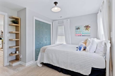This cheerful bedroom boasts ample natural light from a nice window, creating a bright and inviting atmosphere.  The convenient drawer closet provides ample storage for all your belongings, keeping your space organized and clutter-free.  This well-lit and functional room is perfect for relaxation and productivity