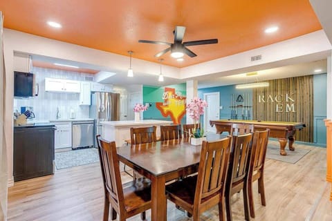 This open space invites guests to enjoy meals at the dining table, chat over drinks, or head to the game room for a round of pool. Whether cooking, eating, or playing, this area is perfect for making every moment with friends & family memorable.