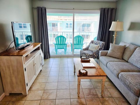 The expansive sliding glass doors allow warming natural light to filter through the space and provide easy access to the private balcony from the living room.