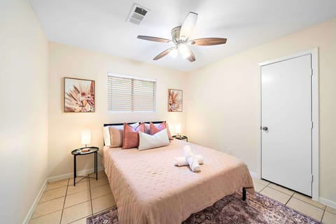 Charming Bedroom: Bright walls, plush bedding, and tasteful decor for a restful retreat!