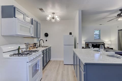 Prepare a gourmet meal or quick snack in this efficient kitchen, then unwind in the cozy bedroom area visible just beyond your dining space.