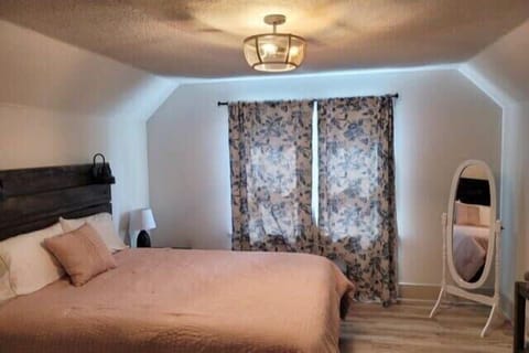 Rest easy in this bright, uncluttered bedroom. Simple comfort for your stay.