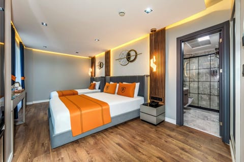 Deluxe Triple Room | Minibar, desk, laptop workspace, soundproofing