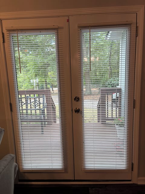 French doors from living room leads to a small deck out front.
