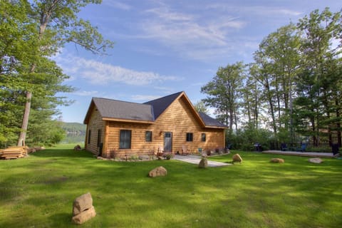 Front of House with Spacious Front Lawn Area and Patio with Seating