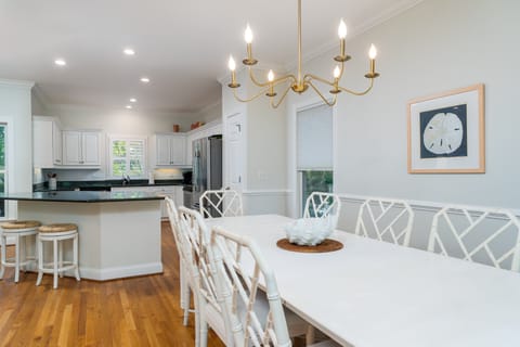 The dining area is open to the kitchen and bar stools at the island area
