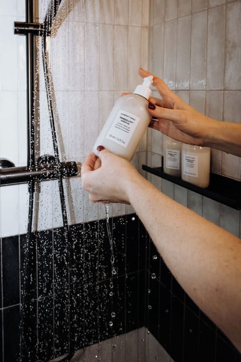 Shower, rainfall showerhead, designer toiletries, hair dryer