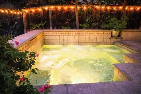 Large in-ground hot tub with waterfalls
