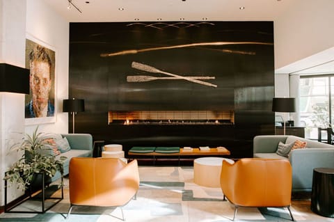 A cozy yet elegant lounge area, highlighted by its striking fireplace and chic furnishings.