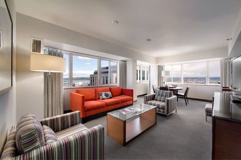 Experience luxury in our spacious suite with panoramic windows, natural light, and a stylish lounge area for ultimate relaxation.