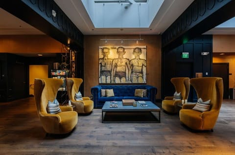 Enjoy the stylish ambiance of our lobby with its striking art pieces and unique mustard swirl chairs that make every moment of your stay memorable.