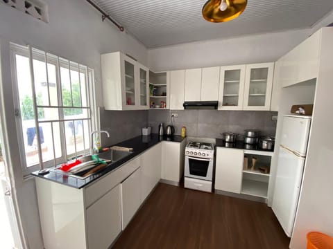 A fully equipped kitchen featuring an oven, microwave, kettle, and a spacious fridge available for use at any time.