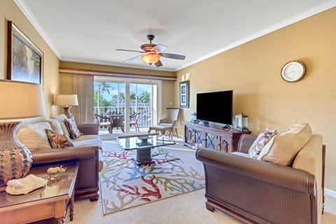 A large sliding glass door fills the space with sunlight and opens to the fully screened balcony.