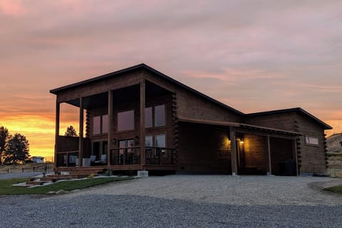 The East Cabin blends rustic-modern architecture with wide Wyoming skies, sunset views, and a covered front deck for taking it all in.