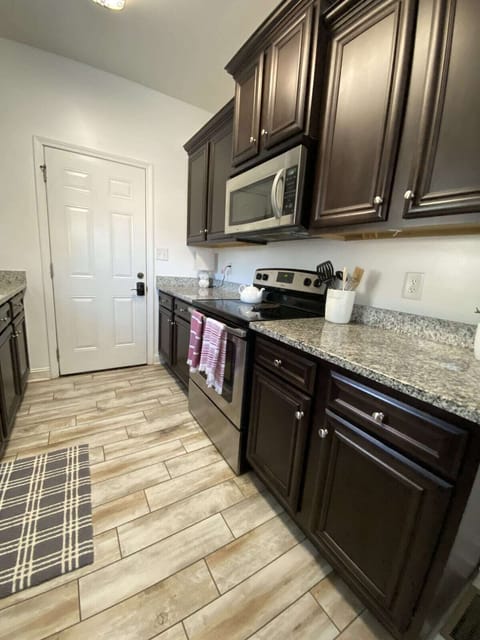 2nd view of kitchen and main entry door.