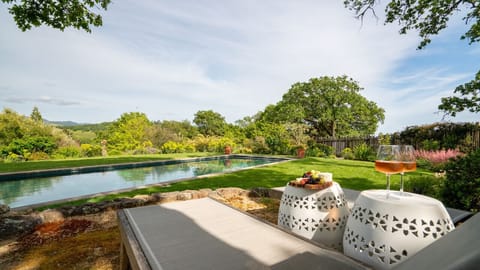 Enjoy a glass of local wine by the pool lounge