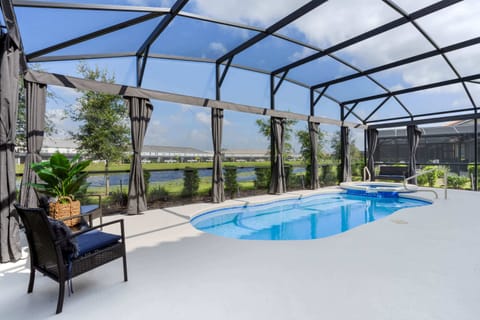 Screened pool and spa with water views, lounge seating, and total privacy.