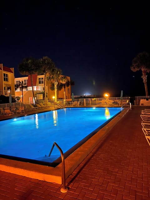 Condo Pool, heated in cooler weather, lit beautifully in the evening time.