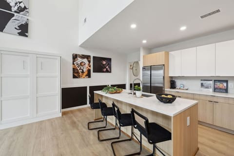 Bright 2-story condo with an open-concept kitchen + living room, space for Murphy beds, and huge windows for natural light. Plus a full downstairs bathroom—perfect for groups and easy, comfortable stays!