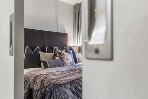 MASTER BEDROOM: Retreat to your serene sanctuary with a plush King bed, soft linens, and blackout curtains for a night of undisturbed rest.