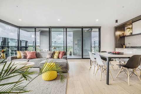 LIVING & DINING ROOM: An open, luminous retreat where natural light dances across the room, seating encourages connection, and comfort is effortless