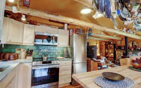 Kitchen with electric stove, microwave refrigerator and island with dishwasher