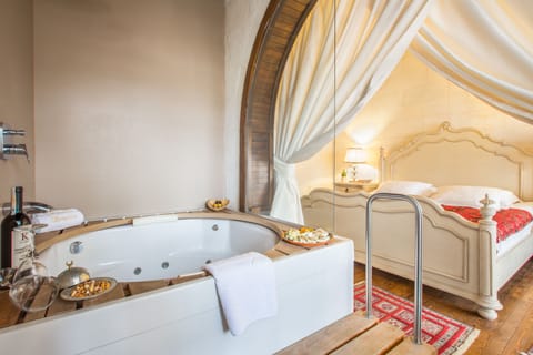 Deluxe Stone Room | Bathroom | Designer toiletries, hair dryer, slippers, towels