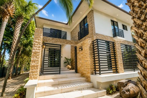 Stylish tropical villa with modern design, palm views, and resort-style curb appeal