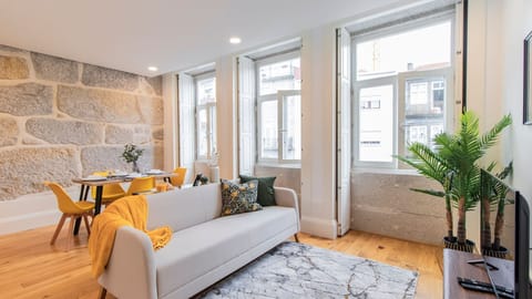 Spacious and ample living room, with a comfortable couch and dining area for four people #bright #wonderful
