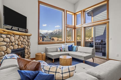Floor to ceiling windows frame the majestic mountain view