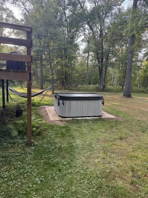 Private hot tub situated on a patio near the forest.