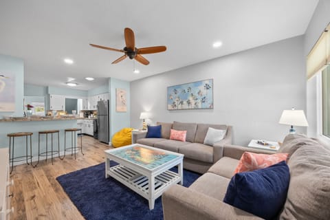 Living Room: Bright and airy space with colorful decor, perfect for relaxation after beach fun!