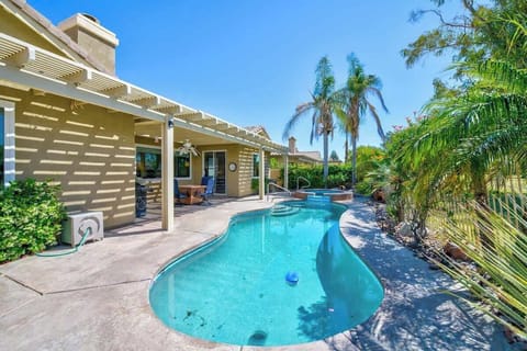 Escape to your private backyard oasis with a pool, shaded outdoor dining, and open fairway views.