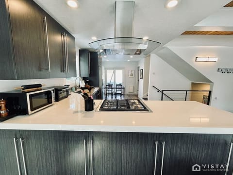 The kitchen is fully equipped with everything you need to prepare delicious meals, featuring modern appliances, cookware, utensils, and ample counter space for your culinary creations.