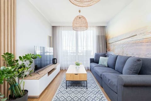 Relax in the stylish living room with a comfortable sofa and modern decor.