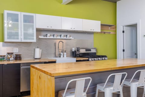 Kitchen has bar seating and 2 dining tables