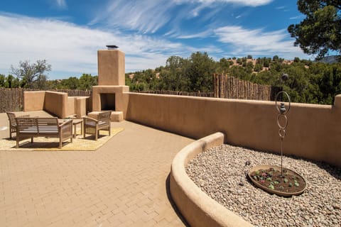 The house has a small fenced back yard beyond the patio.