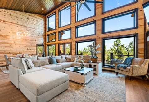 This spacious living room is perfect for relaxing with family. The warm wood paneling adds a charming touch.